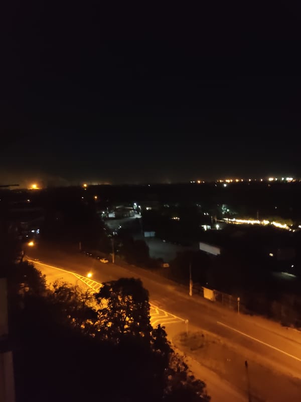 Nighttime aerial views over Zaporizhzhia's lit streets and outskirts