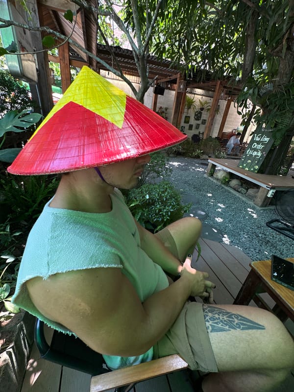 Chilling at an outdoor café in Đà Nẵng, conical hat and all