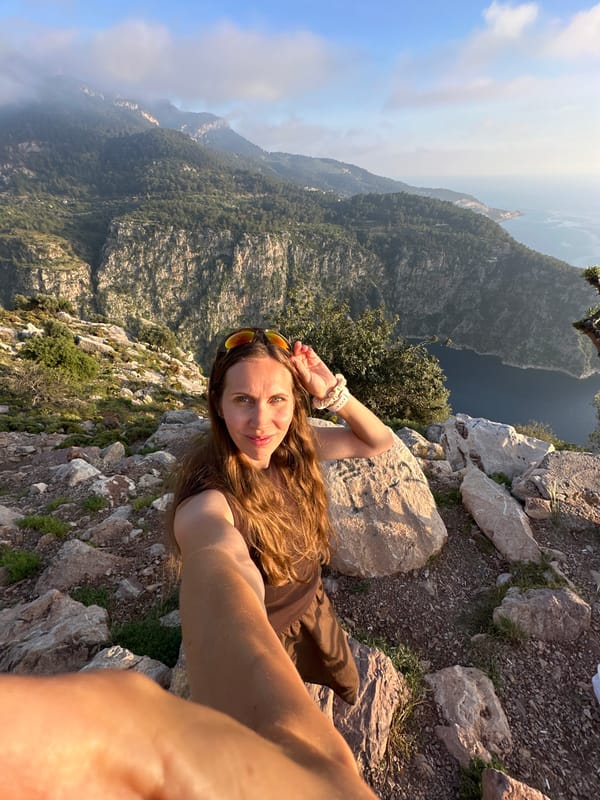 Woman takes selfie at scenic mountain peak in Fethiye