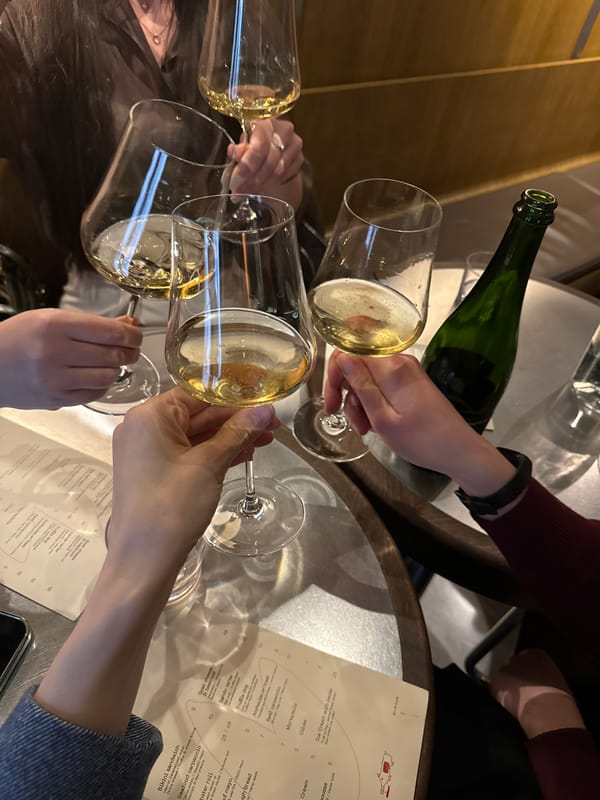 Friends celebrate with sparkling wine at Riga restaurant