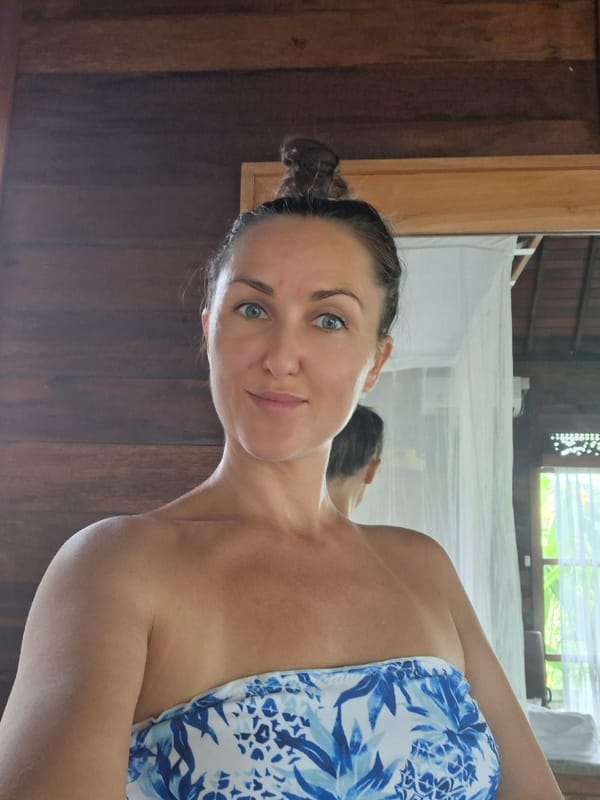 Woman takes morning selfies in rustic Ubud room