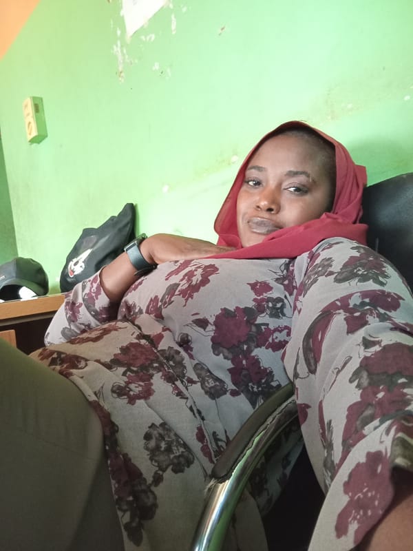 Woman in red headscarf observed in office workspace