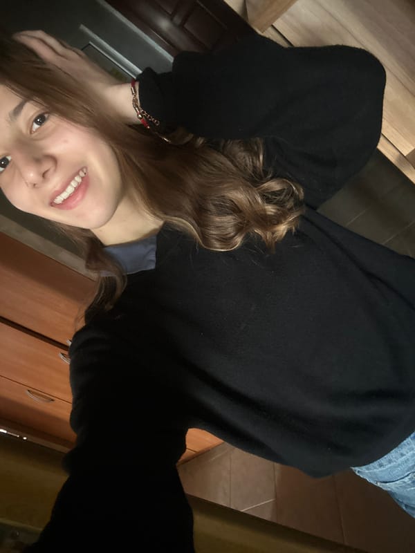 Woman in black sweater photographed indoors in Ruse, Bulgaria