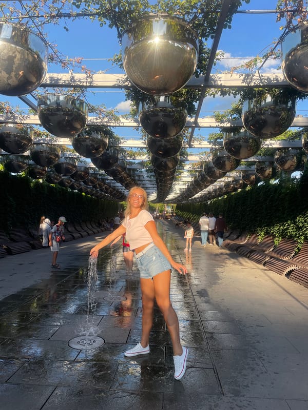 Sunny afternoon at Krasnodar park with fountains and public sculpture