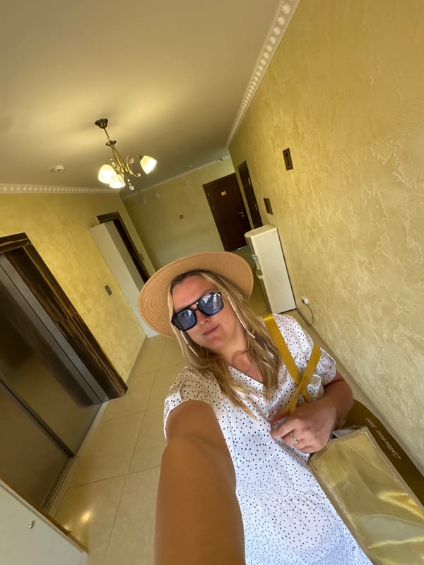 Woman takes selfie wearing hat and sunglasses in Anapa