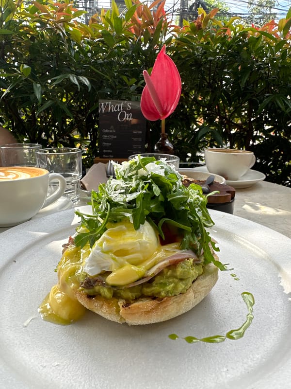 Diner enjoys Eggs Benedict at outdoor cafe