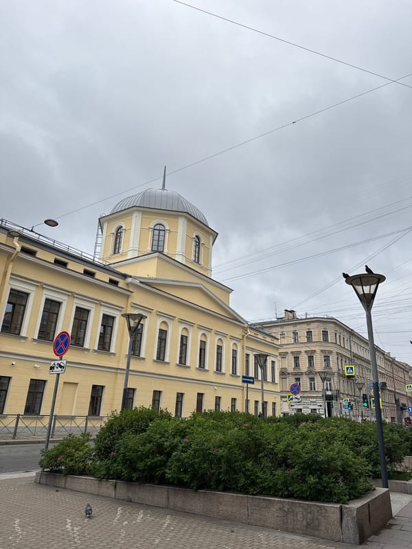 Classic yellow architecture and a dome on a cloudy Saint Petersburg street