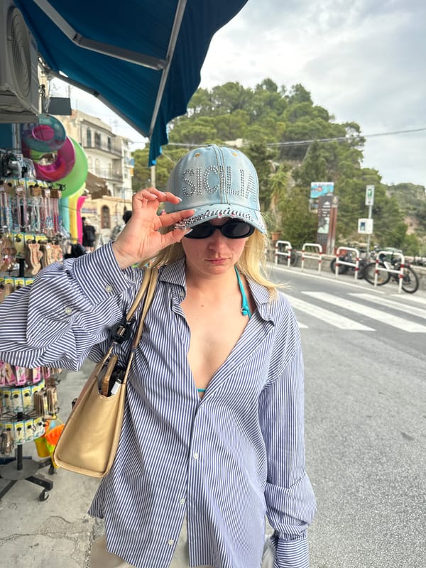 Tourist captures street scenes and coastal views in Taormina
