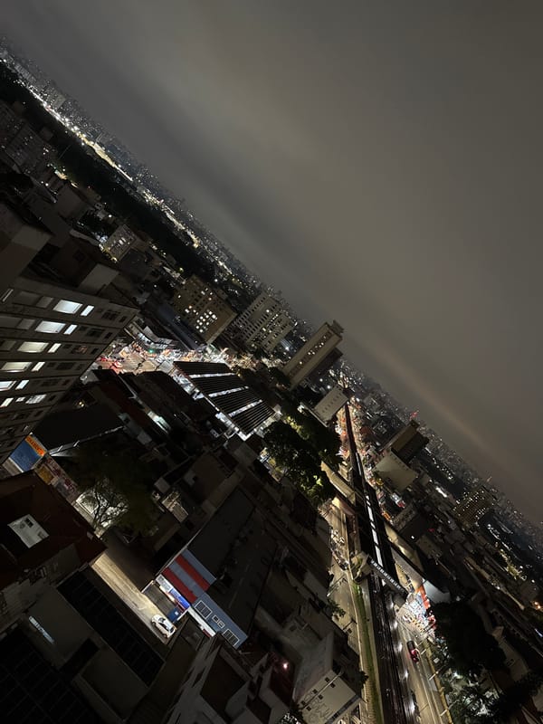 Night observer documents São Paulo cityscape and street gatherings