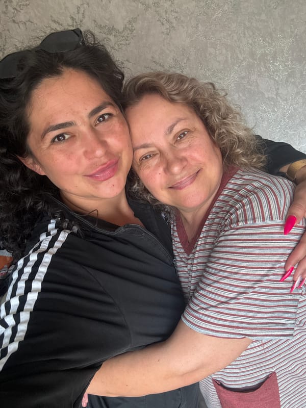 Two women rest together on couch in Кемуль