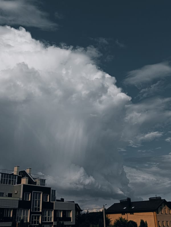Storm clouds build over a residential neighborhood