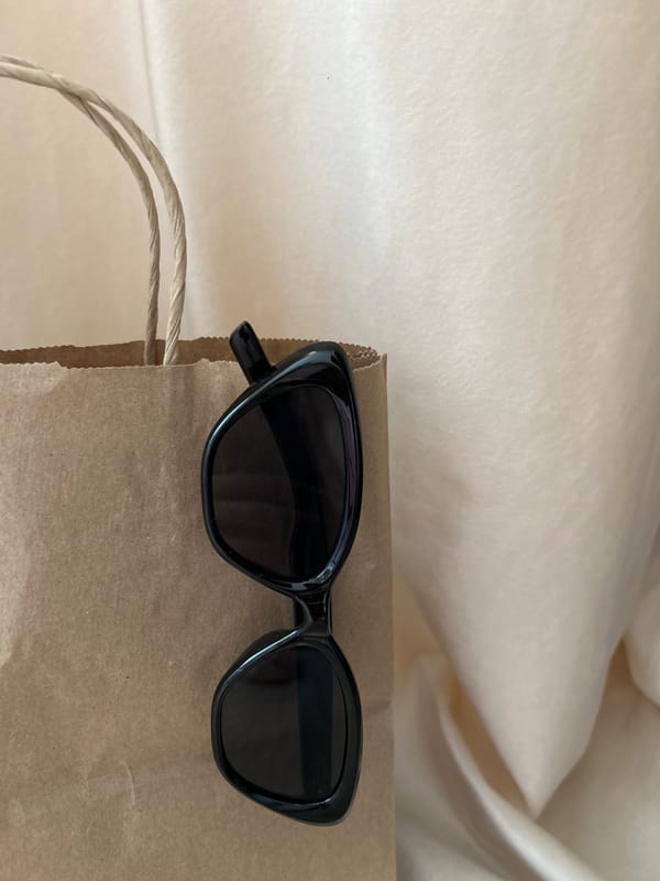 Black sunglasses photographed on paper bag in Ufa