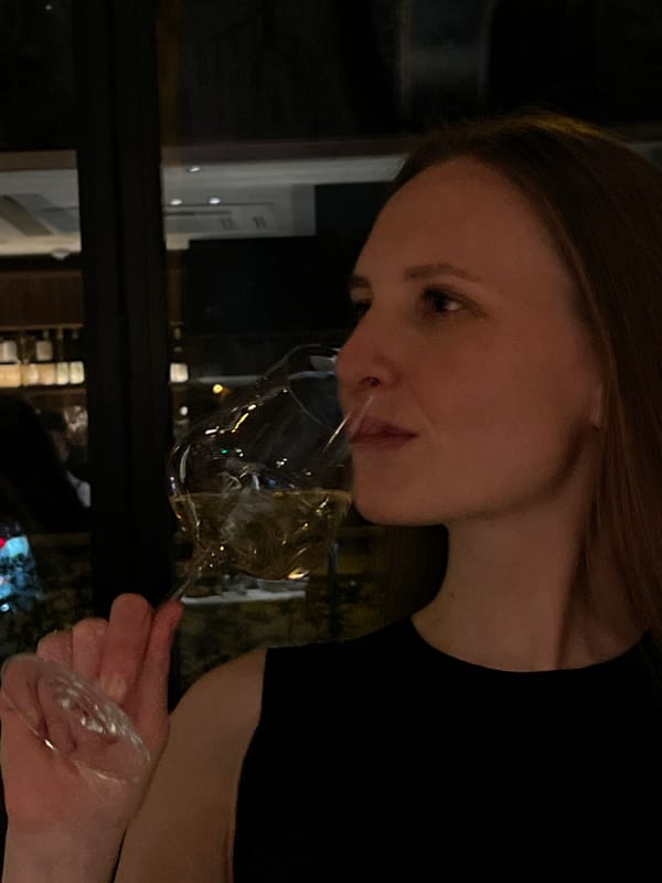 Woman enjoys wine at upscale restaurant Friday evening