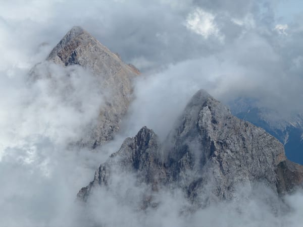 Zugspitze peaks disappear into summer cloud and fog