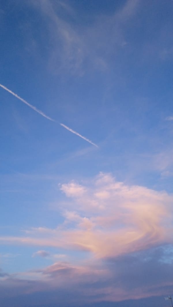 Sunset sky with clouds and contrails, shot over 16 minutes