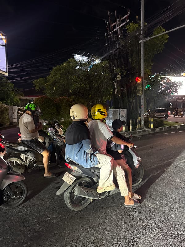 Kuta intersection at night, rain-slicked streets and traffic lights