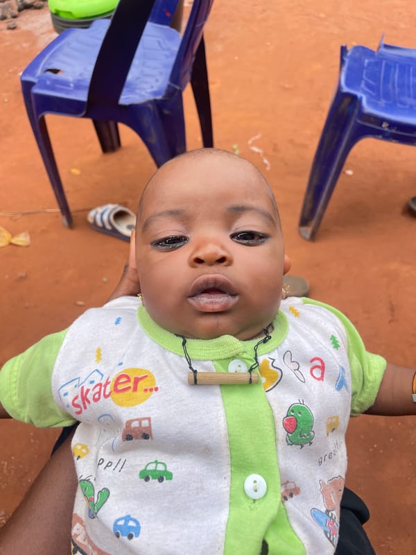 Baby photographed in residential setting in Ogbe, Nigeria