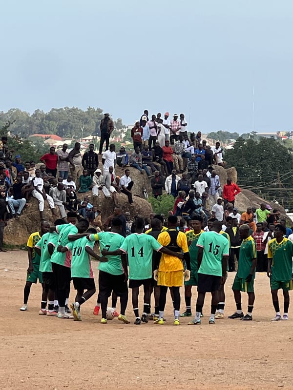 Football match on a dirt pitch in Jos, Nigeria.