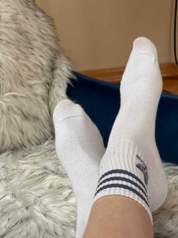 Person rests feet on rug in Budva home