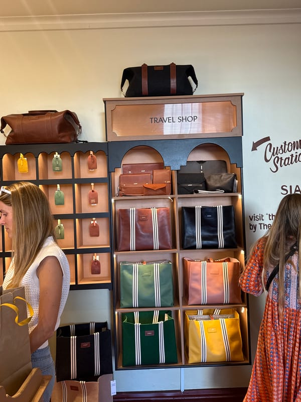 Woman browses luggage tags at travel accessories shop