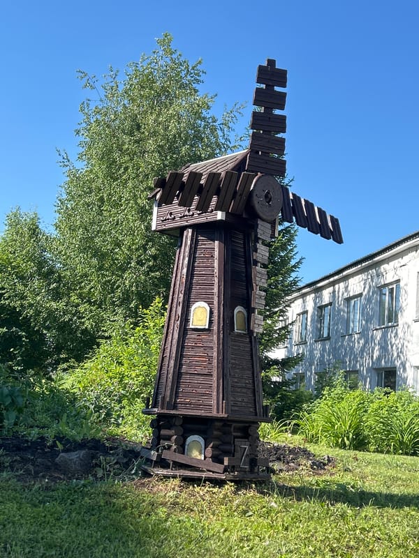Decorative windmill and garden bench in Zelenogorsky, Russia