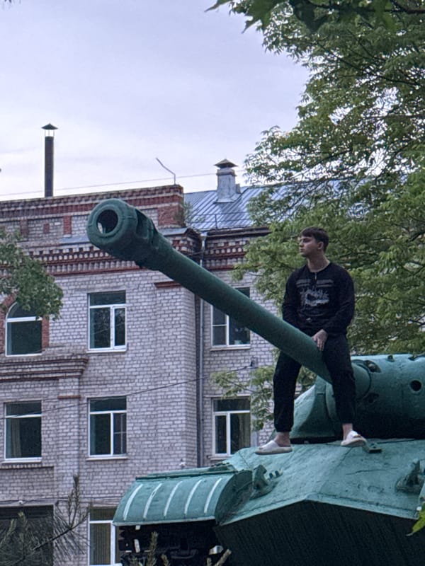 Young person poses on Soviet tank monument in Birobidzhan park