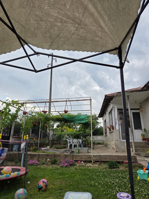 White canopy set up in a backyard in rural Bulgaria