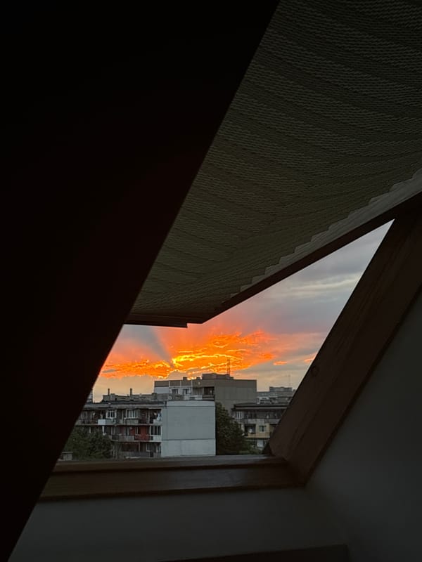 Urban sunset captured through window in Sofia, Bulgaria