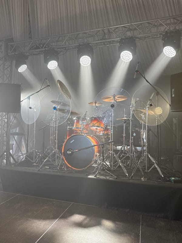 Drummer with sticks observed over drum set in Shchekutino