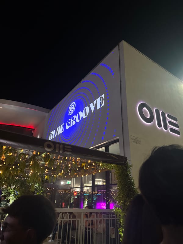 Nightclub exterior with illuminated signage captured in Turin