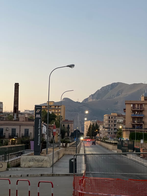 Palermo streets at dusk, quiet corners and mountain backdrop