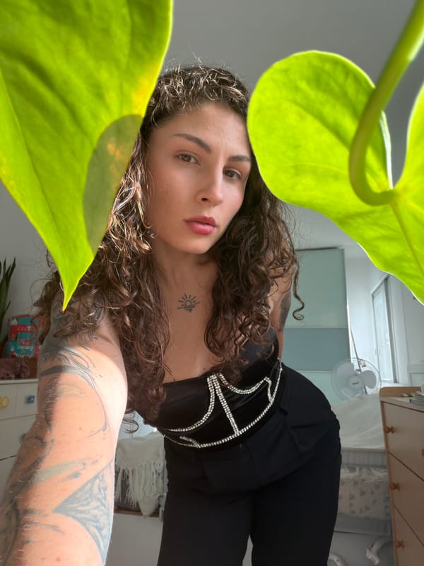 Woman takes selfies with foliage in Kiryat Bialik