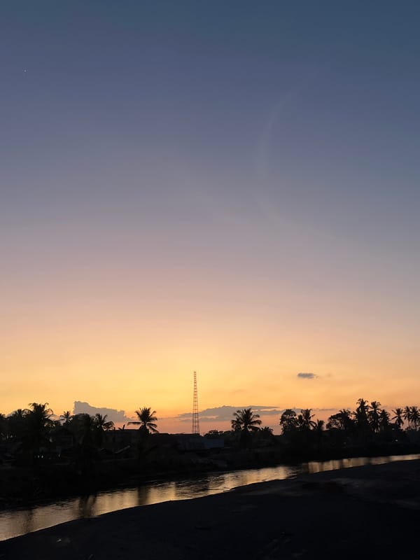 Warm sunset reflections over a river in Meunasah Pupu