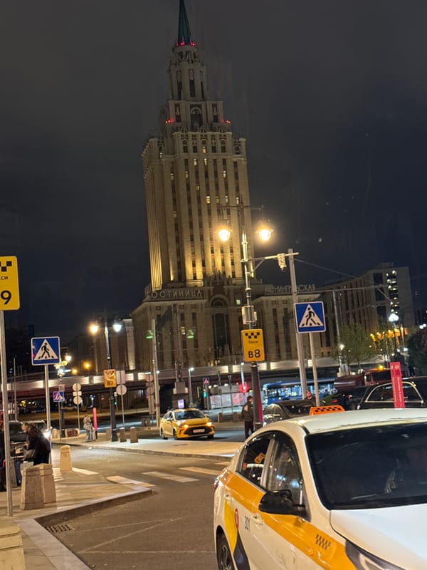 Moscow's Hotel Leningradskaya photographed at night with taxi nearby