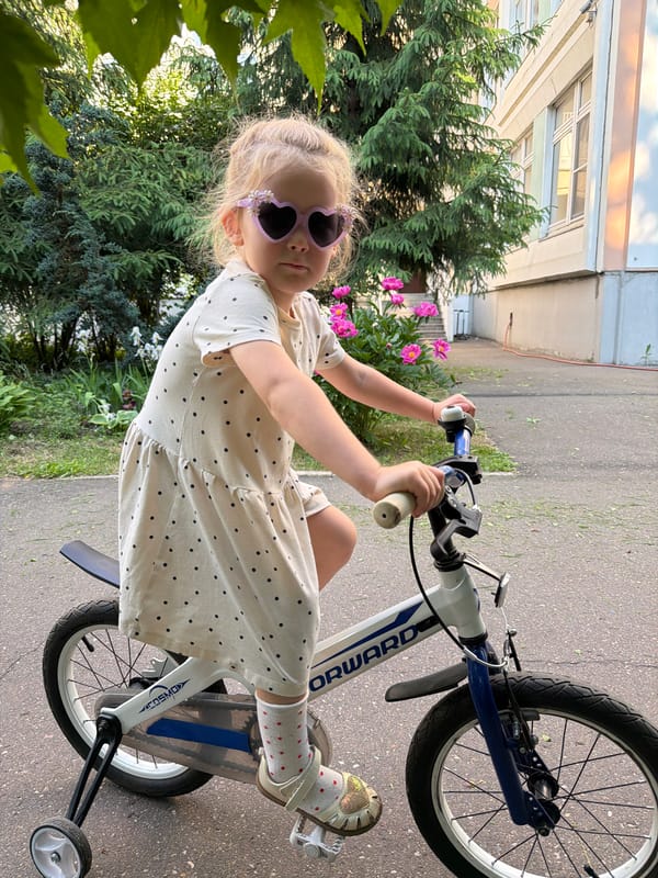 Child plays at Moscow playground amid blooming peonies