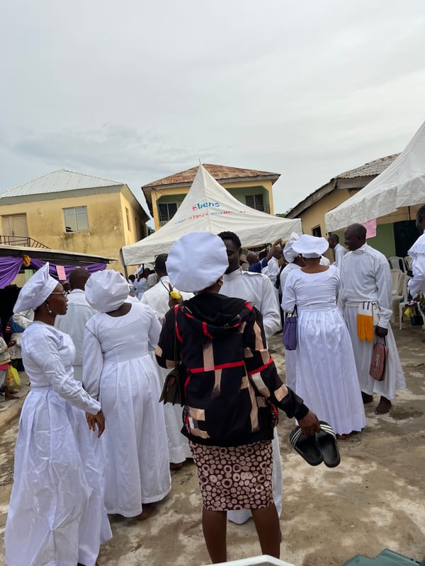 Community religious gathering with drumming, white robes, and ceremony