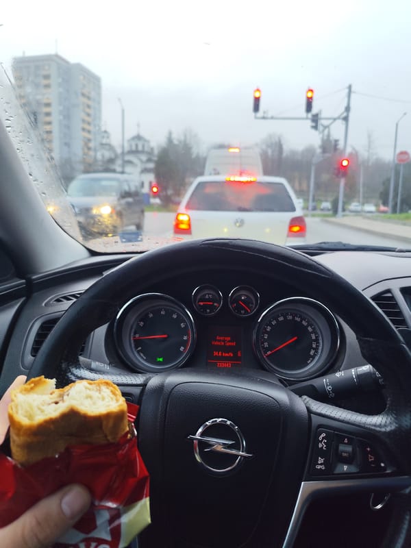 Driver eats pastry at red light during rain