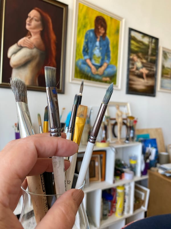 Artist's studio with paintbrushes and portraits documented in Bílina