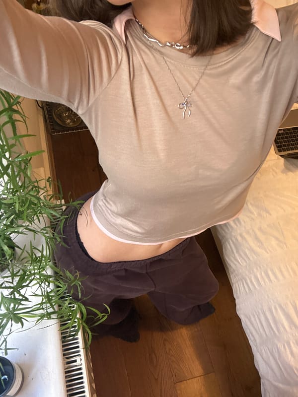 Person photographed in beige outfit taking selfie indoors London