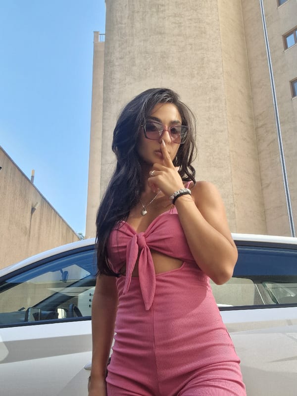 Pink outfit, white car, small dog — a casual day out