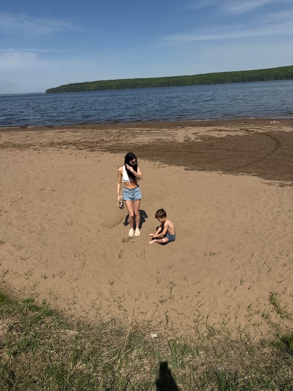 Woman and child enjoy sunny morning at Chaikovsky beach