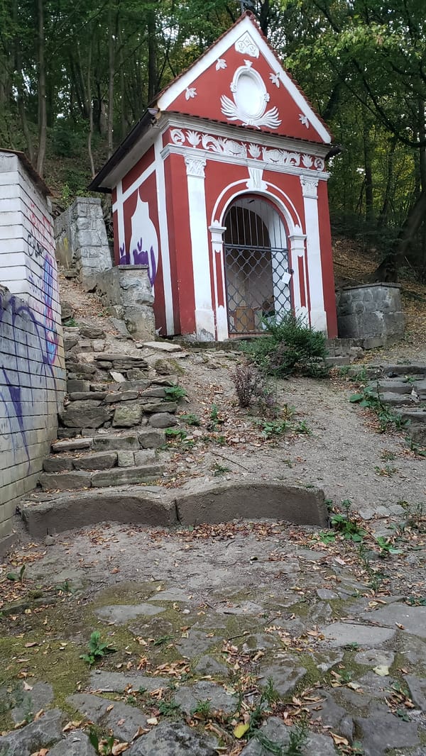 Dusk falls over Prešov's hills, chapels, and cobblestone paths