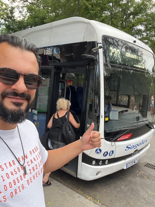 Thumbs-up in front of a white bus, Mollet del Vallès