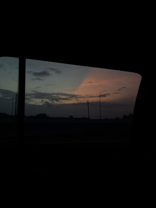 Dawn sky observed through vehicle window in Frisco