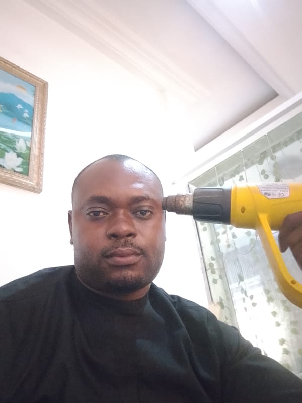 Man with heat gun, woman writing documented in Gwarinpa