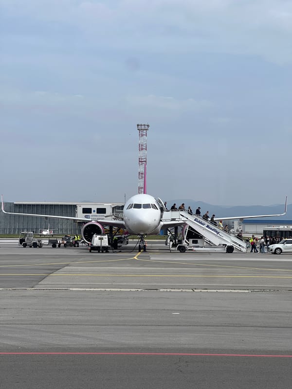Airbus A320 parked at Sofia Airport with ground support