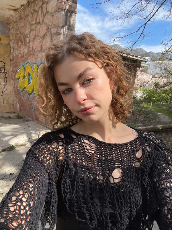 Woman in heart sunglasses poses with cacti in Kamenovo