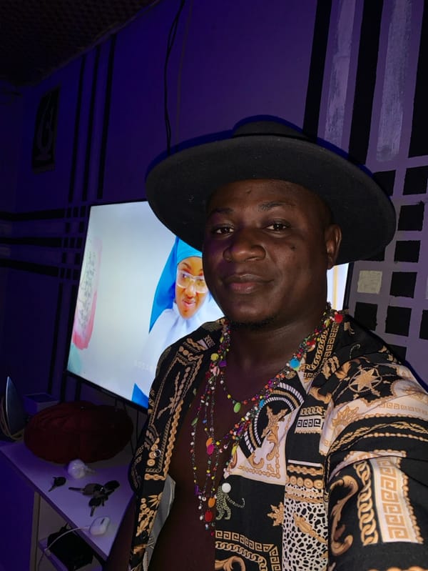 Friends pose playfully indoors during evening gathering in Akwanga