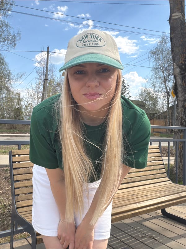 Woman in Yankees cap enjoys spring morning by Votkinsk waterfront