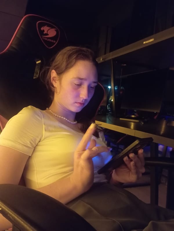 Woman uses smartphone in gaming chair in Tashkent